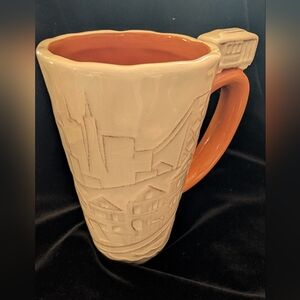 SF Mercantile Ceramic Mug with Orange Handle.